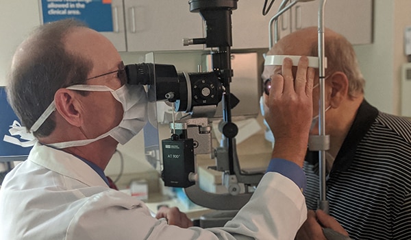 A doctor examining a patients eyes