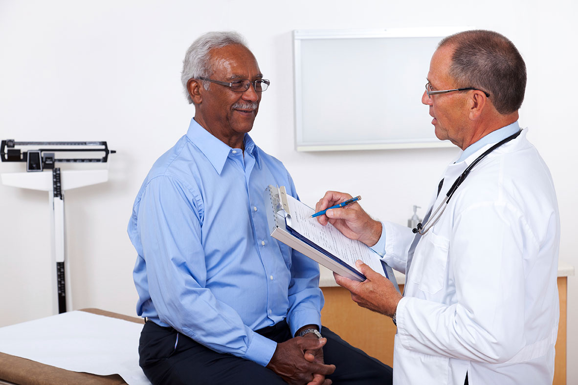 Doctor talking with older male patient.