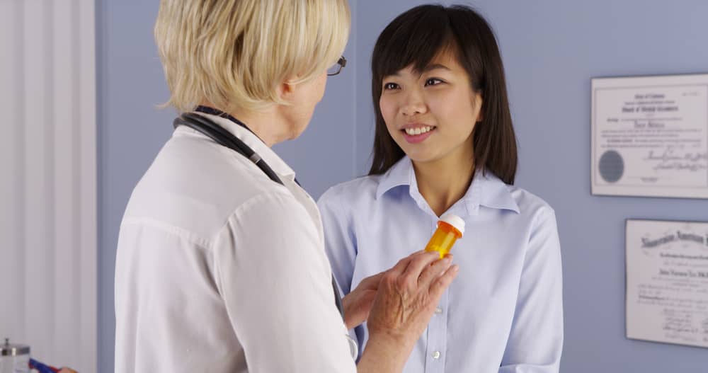 A doctor talking with a patient about a prescription medicine.