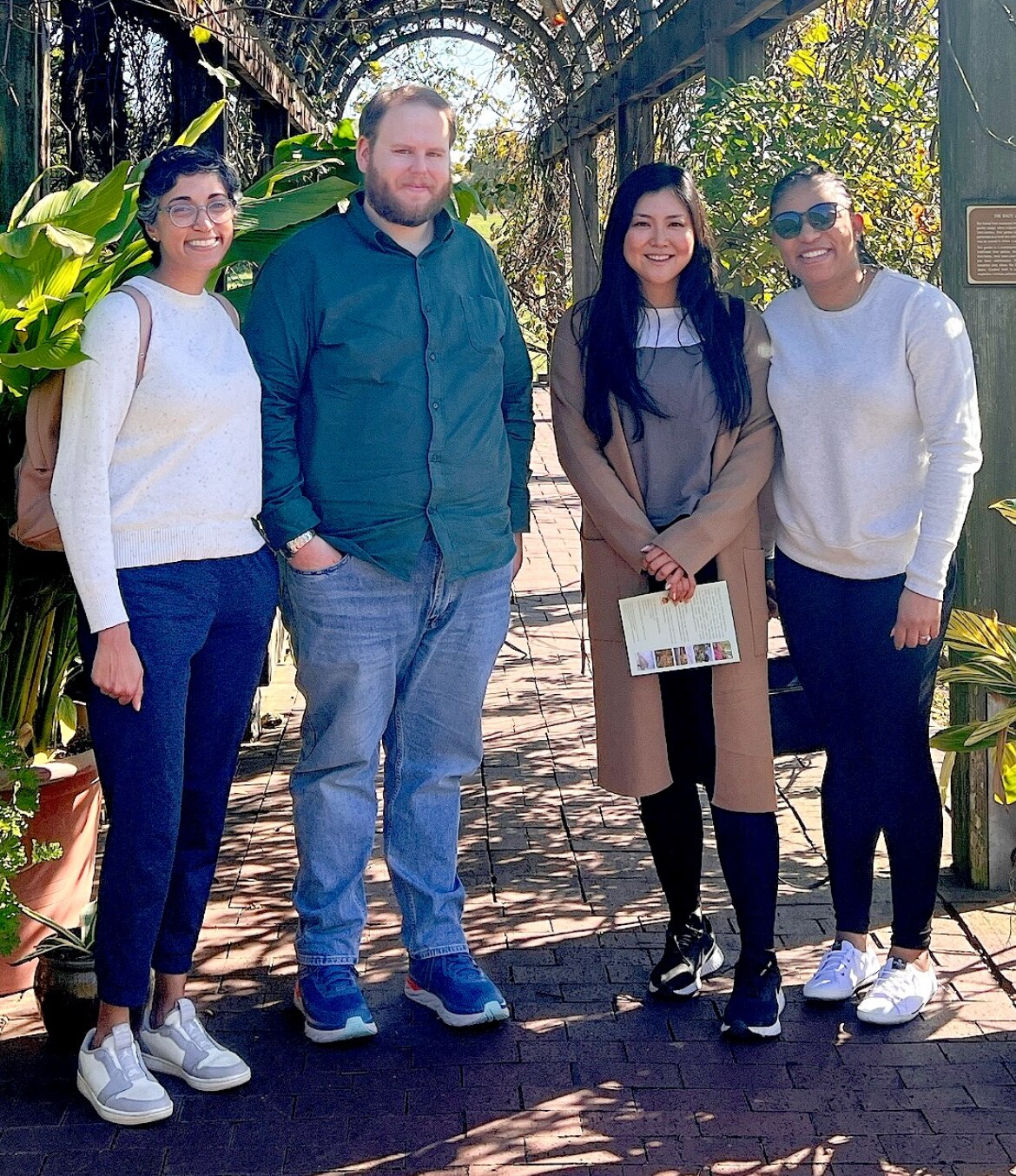 Lab members standing and smiling outside.